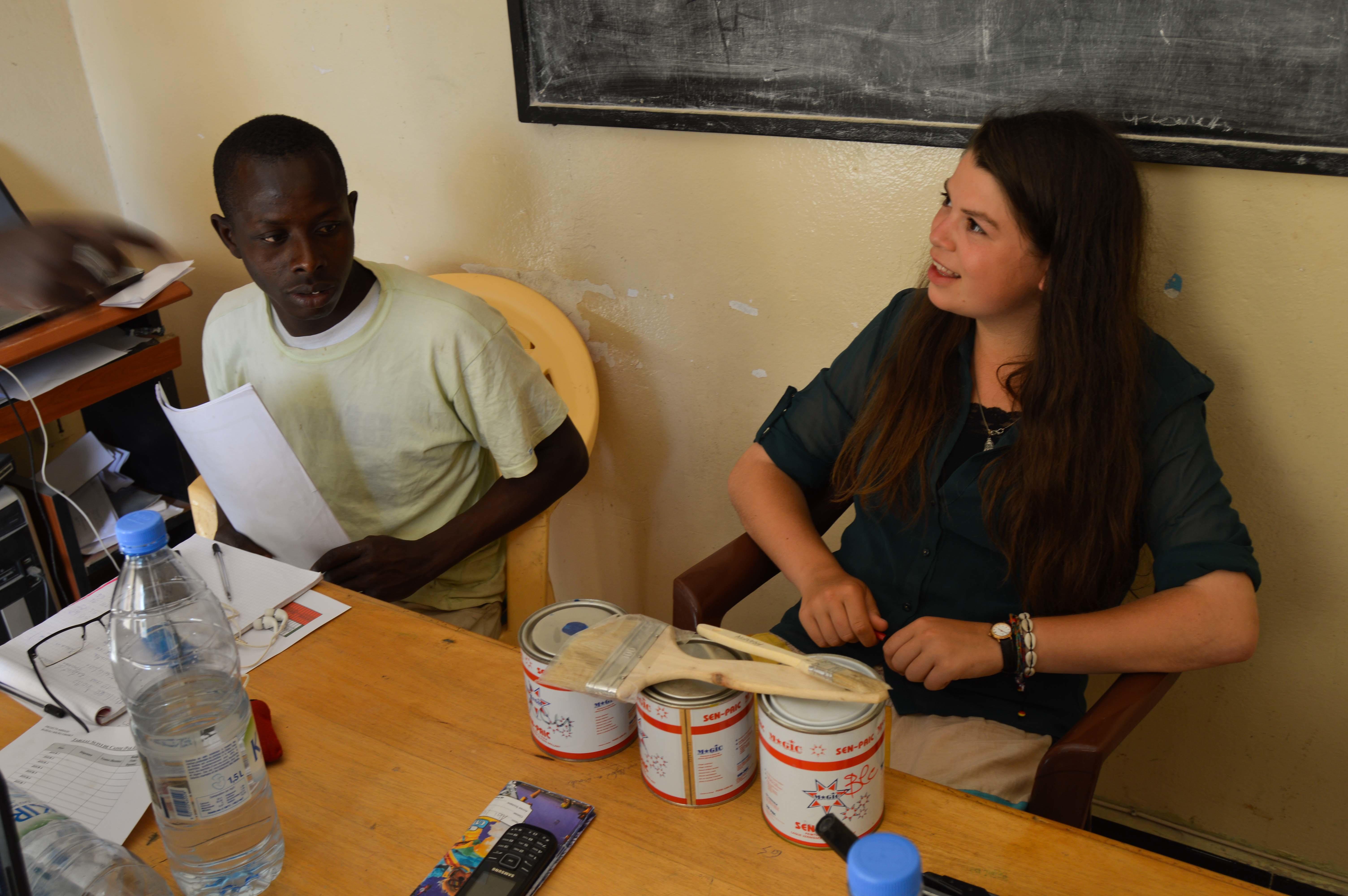 A Projects Abroad intern talks to a project beneficiary at the micro-finance placement in Senegal. A student speaks with a project beneficiary during her Micro-finance internship in Senegal.